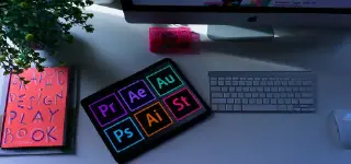 A book, tablet, mouse, keyboard and monitor on a desktop